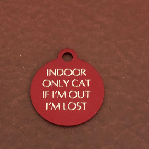 Small red circle tag that says: Indoor only cat If I'm out I'm lost. All engraved in capital letters.