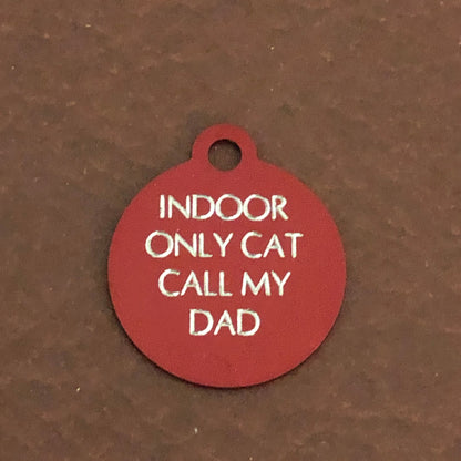 Small red circle tag that says: Indoor only cat call my dad. All engraved in capital letters.